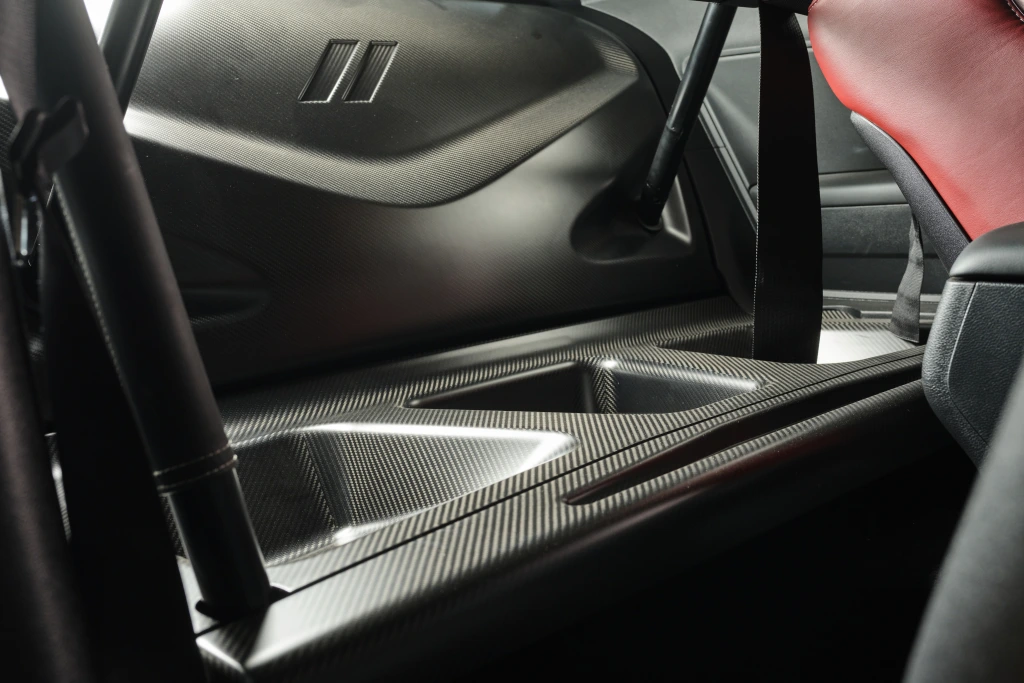 Rear seat delete specially designed trim panels including floor and back panels. Made from pre-preg carbon fiber, this upgrade will reduce weight while improving the look of your interior.